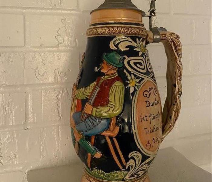 family urn restored from fire damage sitting on a mantle