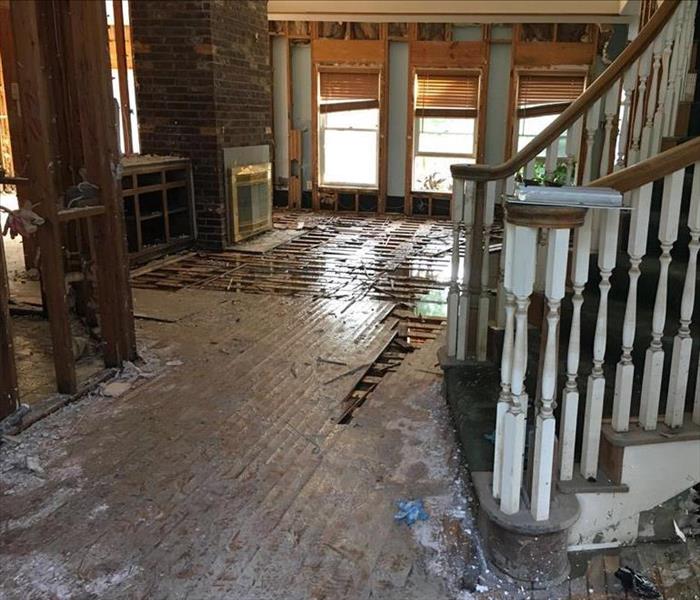 flooded family room with staircase